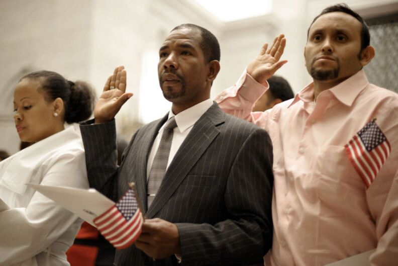 Citizenship applicants are sworn-in during a naturalization ceremony September 17, 2012 at the National Archives in Washington, DC. The ceremony was held at the archives in honor of the 225th anniversary of the signing of the US Constitution.