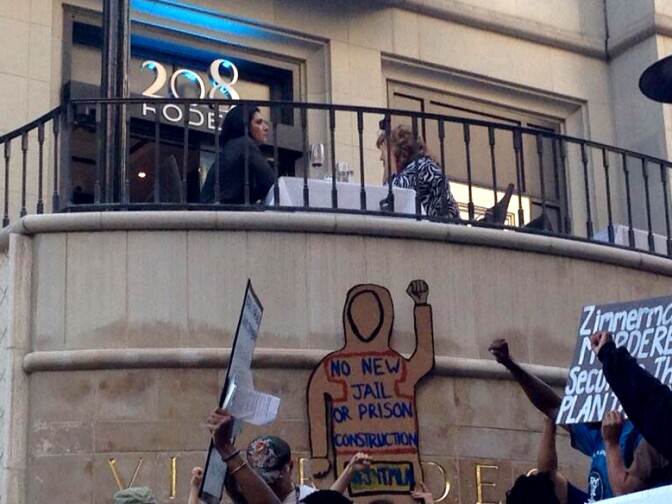 Diners on Rodeo Dr making an attempt at pretending they're not noshing in the middle of a protest Wednesday. 