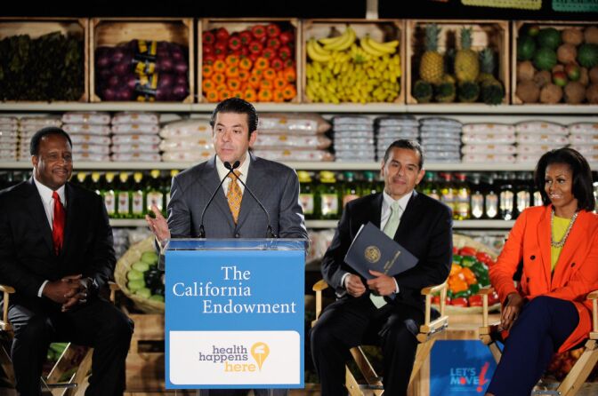 Oscar Gonzalez, co president of Northgare Gonzalez Markets, speaks speaks at the future site of Northgate Gonzalez Market as First lady Michelle Obama (R) Inglewood Mayor James Butts (L) Los Angeles City Mayor Antonio Villaraigosa (2ndR) look  look on February 1, 2012 in Inglewood, California. The $264 million public-private fund plans to bring healthy food stores to under-served communities and create or retain up to six thousand jobs. The fund has committed $20 million in financing to Northgate for the first three projects, which are in South Los Angeles, Inglewood and the City Heights portion of San Diego. The first lady will end her two-day visit with a television appearance to promote her fight against childhood obesity and a fundraiser for her husband U.S. President Barack Obama.  