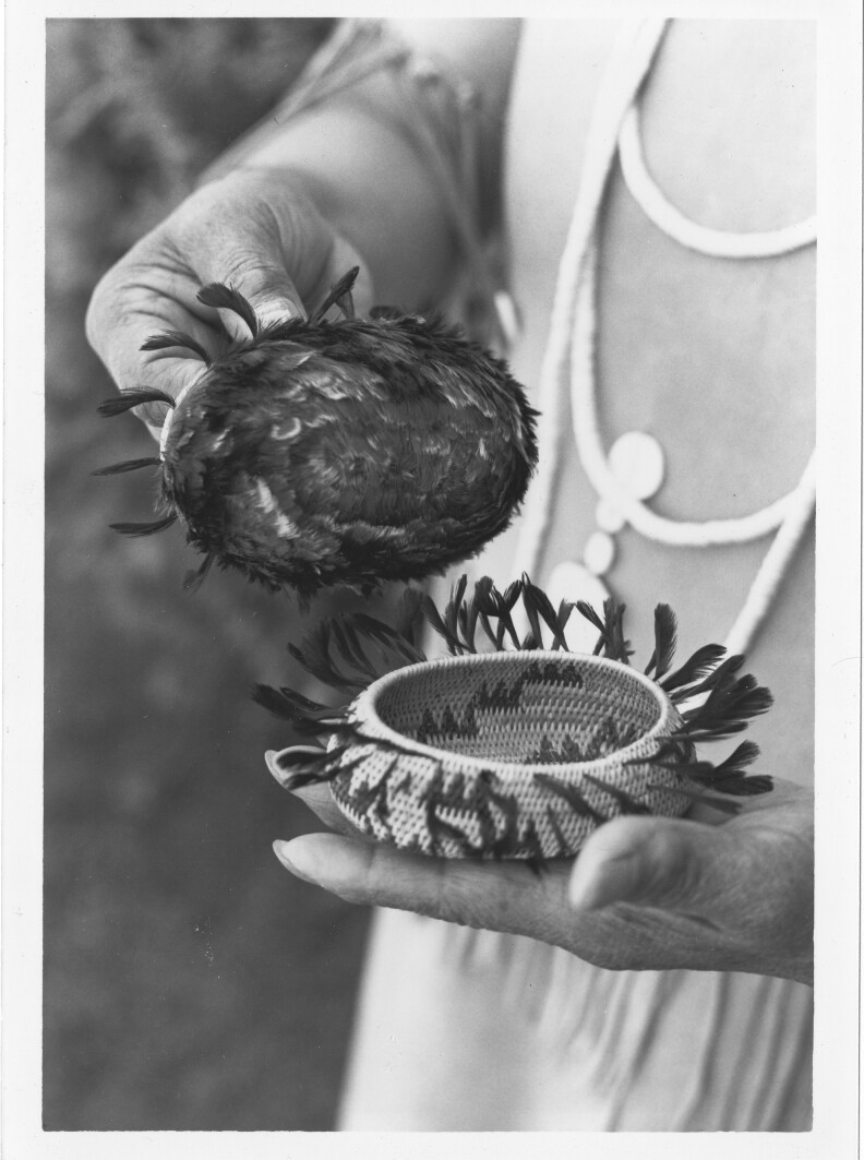 Photograph of Mabel McKay holding two of her baskets.