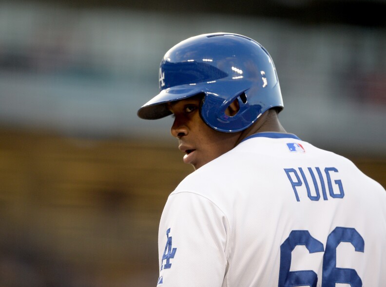 Yasiel Puig #66 of the Los Angeles Dodgers on first base after his single in his major league debut against the San Diego Padres during the first inning at Dodger Stadium on June 3, 2013 in Los Angeles, California.