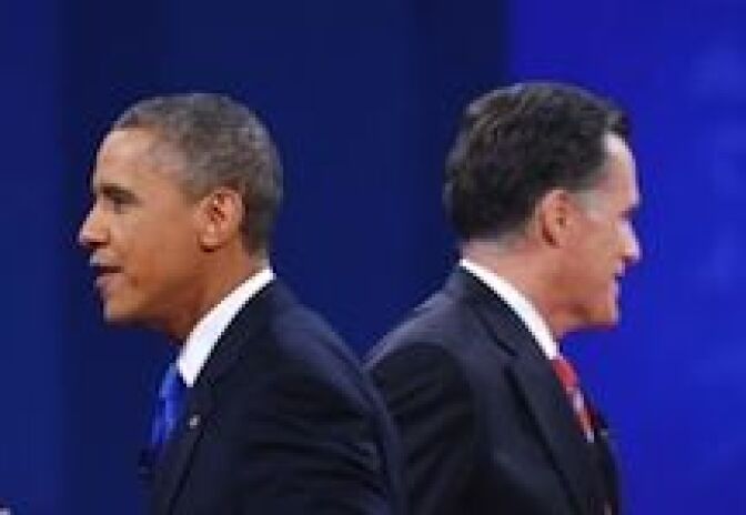 US President Barack Obama Republican presidential candidate Mitt Romney make their way to greet their wives at the end of the third and final presidential debate October 22, 2012 at Lynn University in Boca Raton, Florida. 