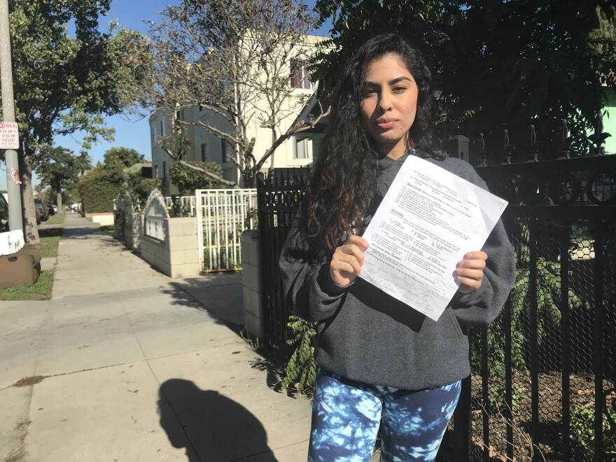 Jeanette Ruiz holds a copy of the final exam that included a question she said made her feel "personally attacked."