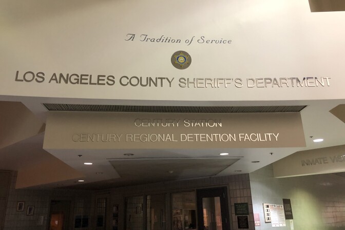 Photo of a building name posted on a wall.