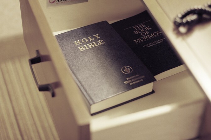 A Bible and the Book of Mormon lay in a hotel drawer.