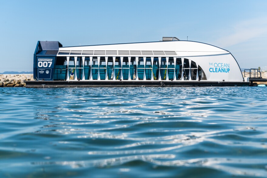 A boat with a curved front and flat back has a series of openings along the side