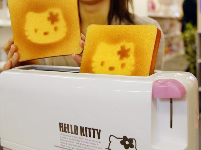 A Sanrio employee displays a Hello Kitty designed toaster celebrating Hello Kitty's 30th birthday in 2004.