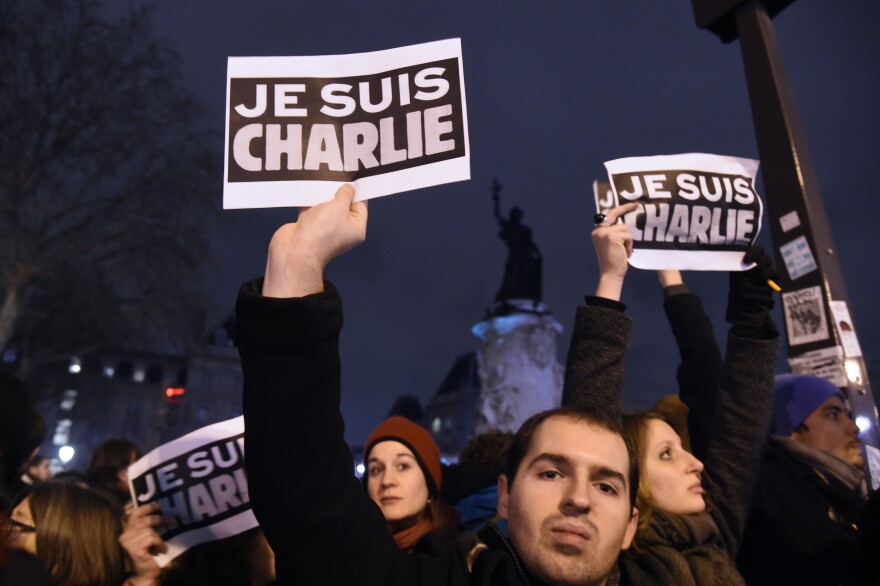 People hold placards reading in French "I am Charlie" during a gathering at the Place de la Republique (Republic square) in Paris, on January 7, 2015, following an attack by unknown gunmen on the offices of the satirical weekly, Charlie Hebdo. France's Muslim leadership sharply condemned the shooting at the Paris satirical weekly that left at least 12 people dead as a "barbaric" attack and an assault on press freedom and democracy. AFP PHOTO / DOMINIQUE FAGET        (Photo credit should read DOMINIQUE FAGET/AFP/Getty Images)