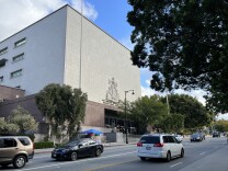 Cars drive past the entrance to the Stanley Mosk Courthouse in Downtown L.A., one of the nation’s busiest trial courts. 