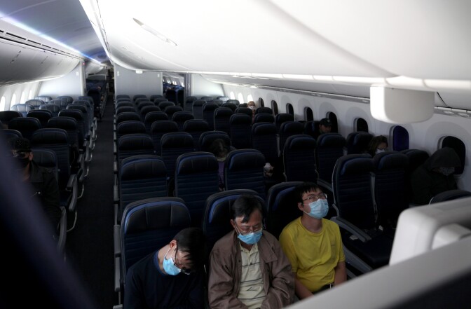 IN FLIGHT  - MAY 11: Passengers sleep while flying on a United Airlines flight on May 11, 2020 in flight to Houston, Texas. Air travel is down as estimated 94 percent due to the coronavirus (COVID-19) pandemic, causing U.S. airlines to take a major financial hit with losses of $350 million to $400 million a day and nearly half of major carriers airplanes are sitting idle. (Photo by Justin Sullivan/Getty Images)