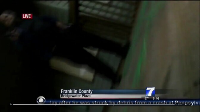 A figure, possibly the suspect, is shown during a live news broadcast from Virginia station WDBJ7 as shots are fired on Wednesday, August 26, 2015. The reporter and photographer were killed.