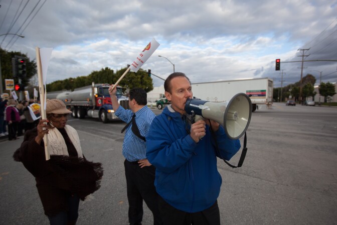 Carson Mayor Jim Dear speaks to protestors outside the Shell Oil facility in South Los Angeles.