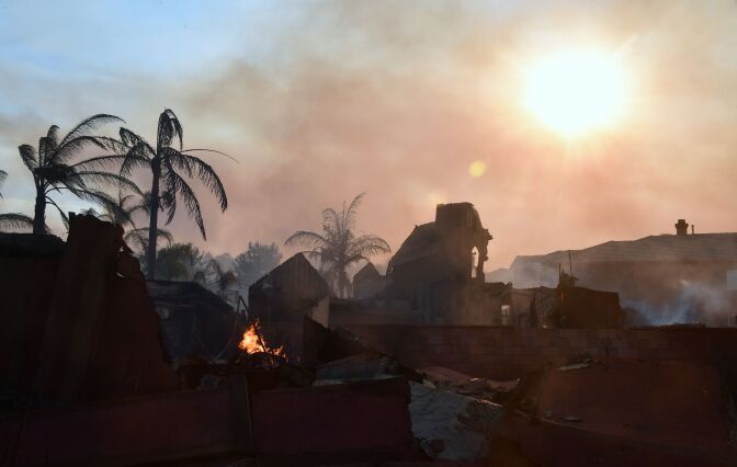 File: Burning embers remain amid demolished homes in the Anaheim Hills neighborhood on Oct. 9, 2017, after the Canyon Fire 2 spread quickly through the area destroying homes.