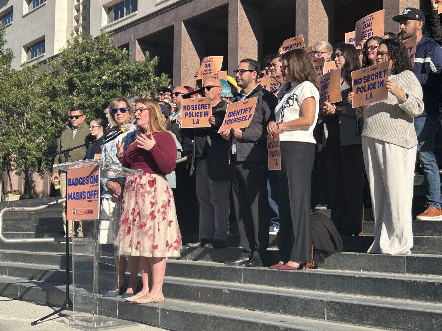 A crowd gathered holding signs
