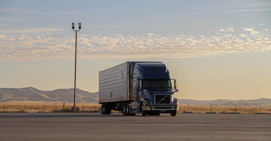 A diesel truck in an empty parking lot.