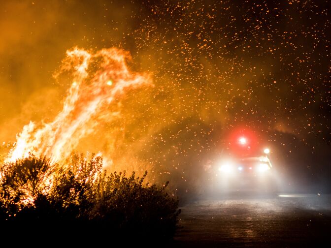 Firefighters work to extinguish the Thomas Fire as it burns past the 101 Highway towards the Pacific Coast Highway in Ventura, California, Dec. 7, 2017. 