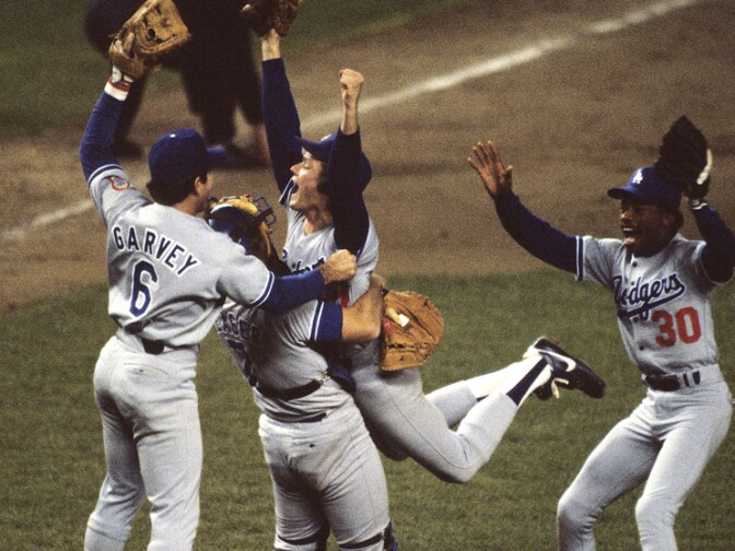 BRONX, NY - OCTOBER 1981:  Steve Howe #57 of the Los Angeles Dodgers jumps into the arms of catcher Steve Yeager #7 of the Los Angeles Dodgers with Steve Garvey #6 and Derrel Thomas #30 also of the Los Angeles Dodgers joining the celebration after winning Game 6 of the 1981 World Series against the New York Yankees on October 28, 1981 in the Bronx, New York.  (Photo by Ronald C. Modra/Sports Imagery/ Getty Images)