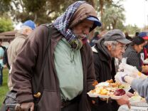 Mark Rice lines up to get a free  meal at Union Station Homeless Services' Thanksgiving dinner last year at Central Park in Pasadena. 