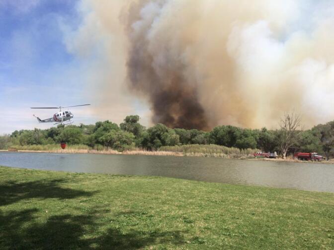 An image posted to Twitter by the San Bernardino County Fire Department shows a wildfire near Victorville that quickly grew to 60 acres, threatened buildings and prompted evacuation orders on Tuesday, March 31, 2015.