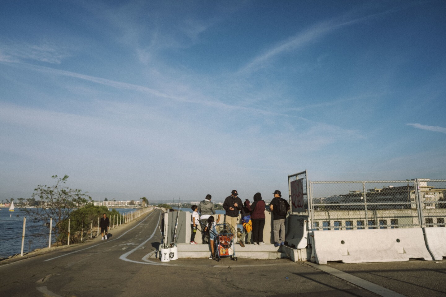 A family hangs out near the end of the Ballona Creek Bike Path after a day of fishing.