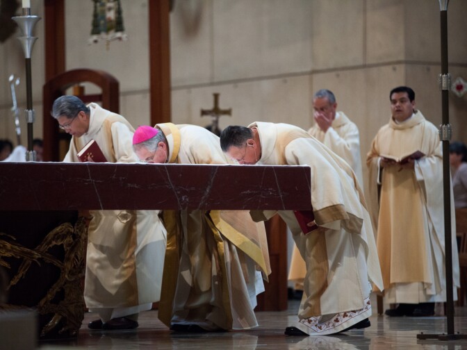Priests at the Cathedral of Our Lady of the Angels kiss the altar on March 13th, 2013 after Jorge Mario Bergoglio was selected to be the new pope.