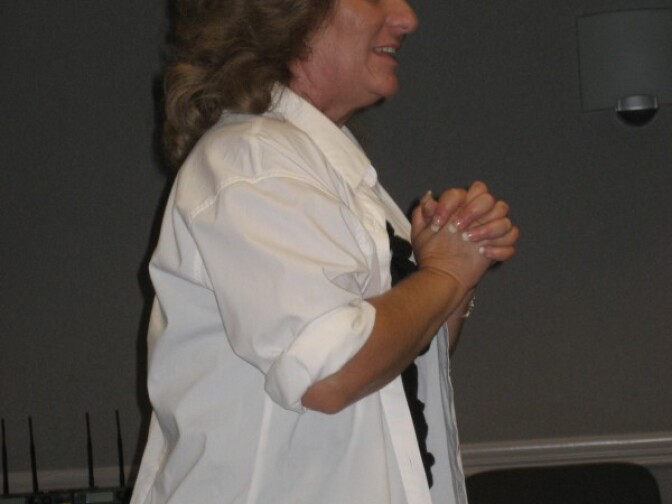 Brenda Clubine talks to a small crowd in Anaheim about her experience with domestic violence.