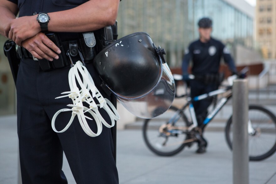 Police equip themselves with riot gear and handcuffs in case the protest gets out of hand.