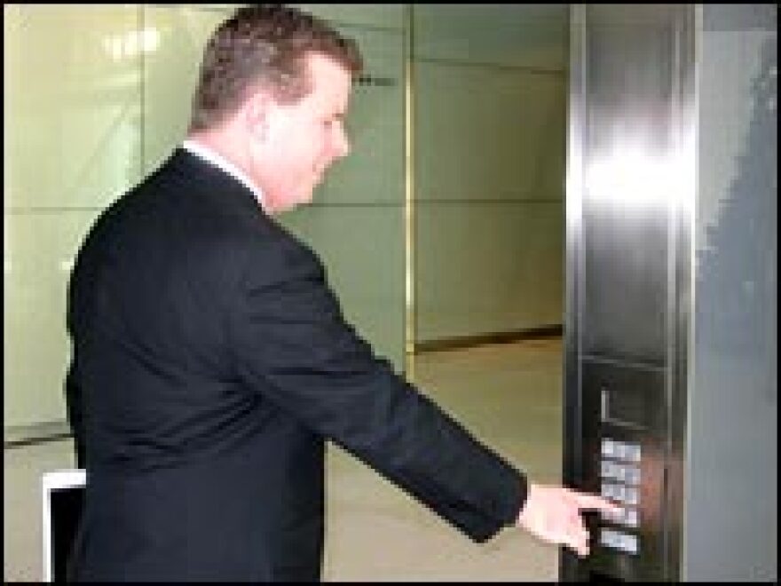 Brian Schwagerl, vice president of real estate at Hearst Corp., demonstrates an elevator keypad in the lobby of the new Hearst Tower in New York City.