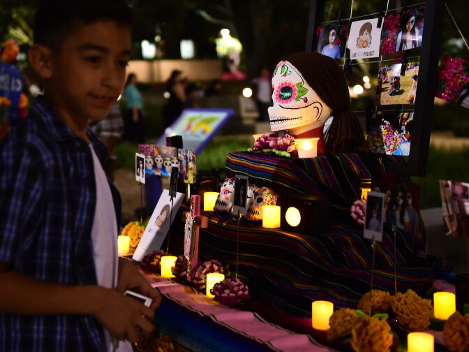 A boy views objects displayed on altars during a traditional Mexican celebration of 'Noche de Ofrenda' (Night of the Altars) in downtown Los Angeles, California on October 25, 2014, a week before the 'Day of the Dead' celebration on November 1.  AFP PHOTO / Frederic J. BROWN        (Photo credit should read FREDERIC J. BROWN/AFP/Getty Images)