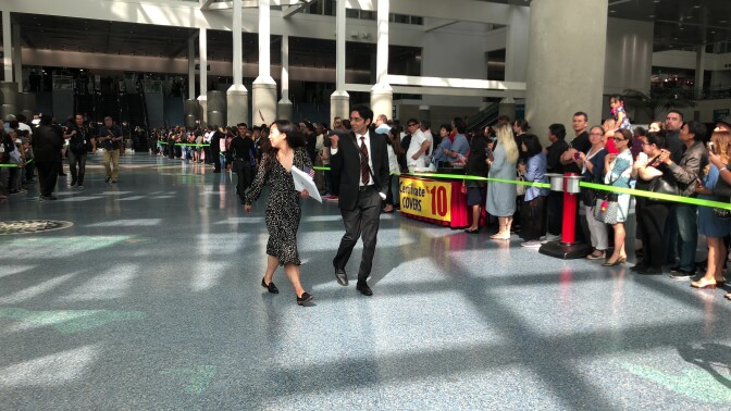 Veteran Yea Ji Sea walks with ACLU Attorney Sameer Ahmad and is met with applause after becoming a US citizen.