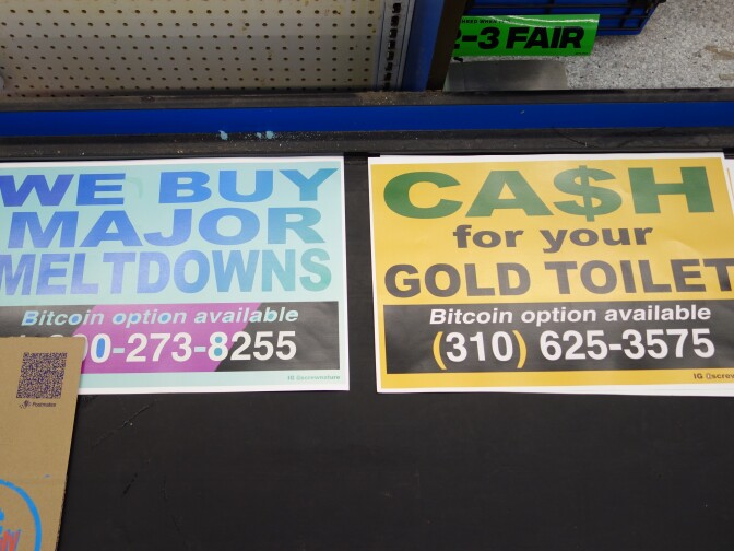 Signs on a supermarket checkout conveyor belt that read "Ca$h for your gold toilet" and "We buy major meltdowns."