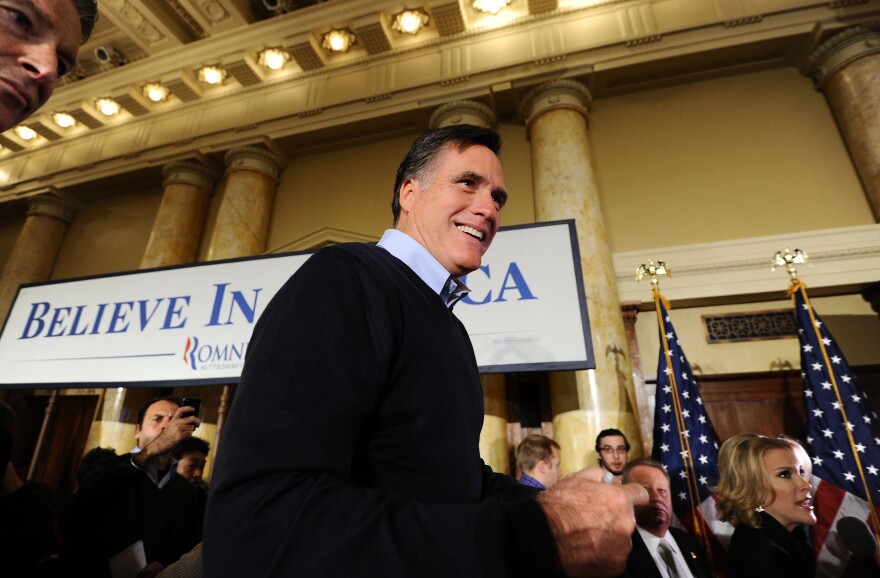 Republican presidential hopeful Mitt Romney greets supporters during a campaign rally in Des Moines, Iowa, on January 3, 2012. Frontrunner Romney on Tuesday focused his last minute attacks on the Democratic president, amid polls suggesting good chances of a win in Iowa. Judgment day dawned for Republican contenders vying to take on Barack Obama in November's presidential election, with a pivotal vote in Iowa Tuesday likely to dramatically winnow the field of contenders. AFP Photo/Jewel Samad (Photo credit should read JEWEL SAMAD/AFP/Getty Images)