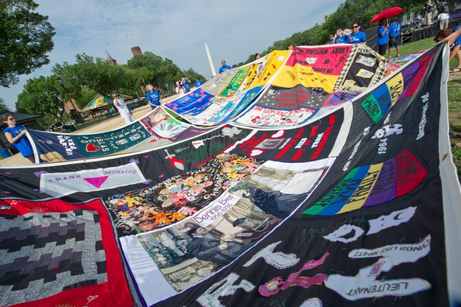 Volunteers lay out the AIDS Quilt on the National Mall July 23, 2012 as part of the 19th International AIDS Conference in Washington, DC. The conference is expected to draw 25,000 people, including politicians, scientists and activists, as well as some of the estimated 34 million people living with HIV who will tell their stories.  AFP PHOTO/Karen BLEIER        (Photo credit should read KAREN BLEIER/AFP/GettyImages)
