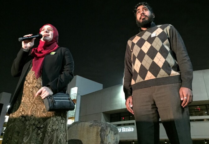 (From l. to r.) Duaa Alwan of the Islamic Shura Council of Southern California addresses the vigil-goers with Syed Hussaini of the Council of American-Islamic Relations.