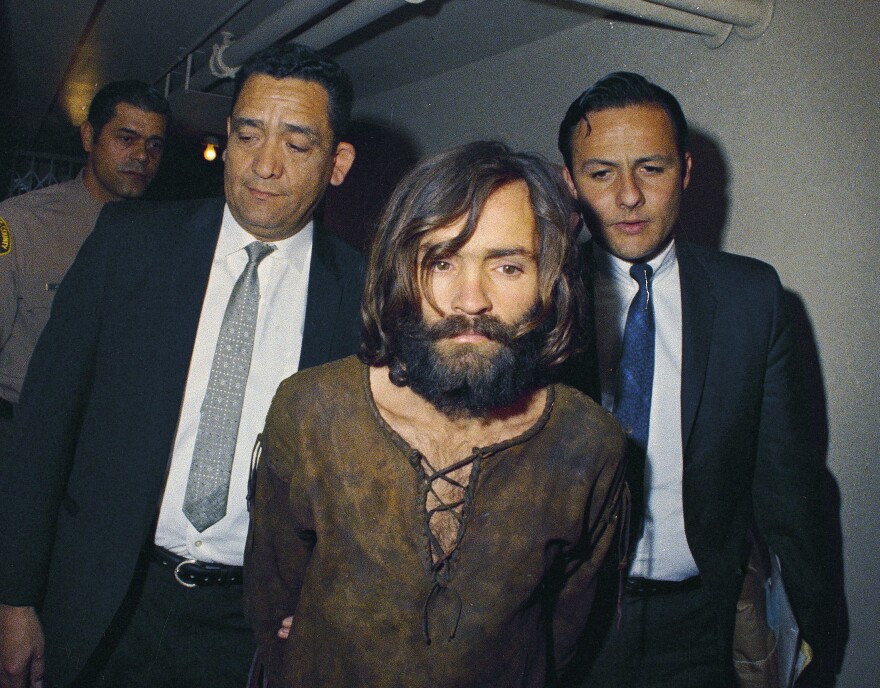 FILE - In this 1969 file photo, Charles Manson is escorted to his arraignment on conspiracy-murder charges in connection with the Sharon Tate murder case.
