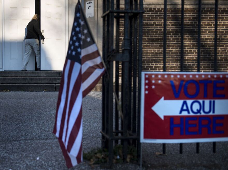 A woman arrives at Tremont Elementary School to vote during election day November 6, 2012 in Cleveland, Ohio. Citizens around the United States head to the polls to vote on the country's next president including in Ohio, a state with 18 electoral votes, were the race between US President Barack Obama and Mitt Romney is very close. 