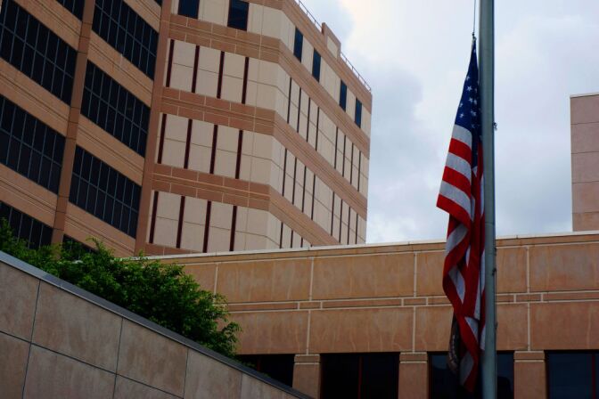 An American flag hangs at half-staff outside the Twin Towers Correctional Facility in Los Angeles on Feb. 8, 2013, in remembrance of a Riverside police officer who was allegedly shot Thursday by murder suspect Christopher Dorner. The correctional facility and adjoining L.A. County Men's Central Jail were on high alert after the report, resulting in area traffic checkpoints conducted by officers in ballistic vests and helmets. The identity of the deceased officer has not yet been released.