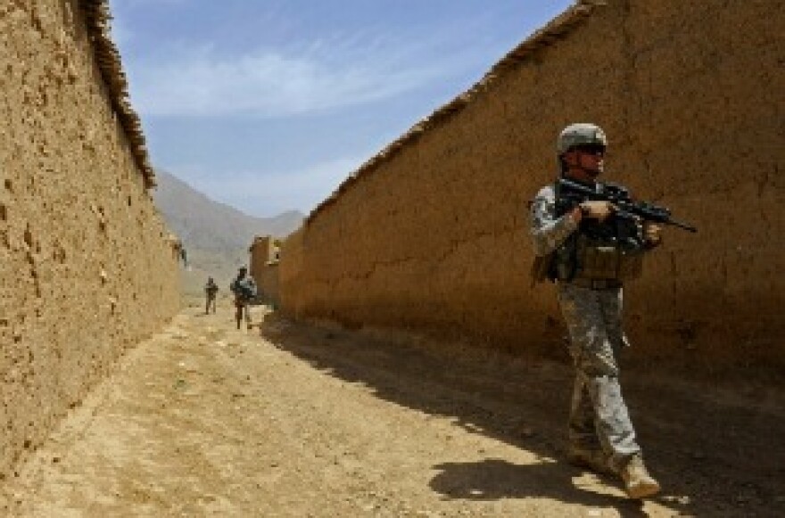In this photo provided by ISAF Regional Command/U.S. Air Force, members of Provincial Reconstruction Team Zabul - Arghandab Detachment, enter May 27, 2011 in the village of Deh Afghanan, Afghanistan.