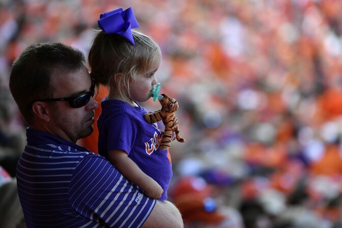 CLEMSON, SC - OCTOBER 07:  A father holds a young Clemson Tigers fan during the Tigers' game against the Wake Forest Demon Deacons at Memorial Stadium on October 7, 2017 in Clemson, South Carolina. (Photo by Mike Comer/Getty Images)