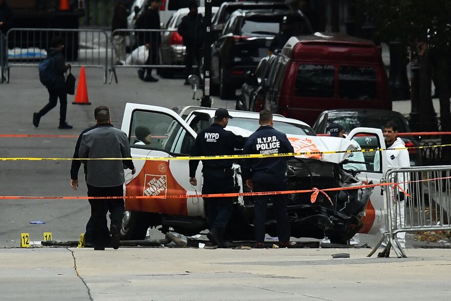Investigators work around the wreckage of a Home Depot pickup truck, a day after it was used in an terror attack, in New York on November 1, 2017.
The pickup truck driver who plowed down a New York cycle path, killing eight people, in the city's worst attack since September 11, was associated with the Islamic State group but "radicalized domestically," the state's governor said Wednesday. The driver, identified as Uzbek national named Sayfullo Saipov was shot by police in the stomach at the end of the rampage, but he was expected to survive. / AFP PHOTO / Jewel SAMAD        (Photo credit should read JEWEL SAMAD/AFP/Getty Images)