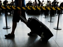 People arrive at John F. Kennedy (JFK) international airport following an announcement by the Supreme Court that it will take President Donald Trump's travel ban case later in the year on June 26, 2017 in New York City.