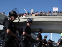 LOS ANGELES, CA - JANUARY 29:  Los Angeles police officers monitor protesters during a demonstration against the immigration ban that was imposed by U.S. President Donald Trump at Los Angeles International Airport on January 29, 2017 in Los Angeles, California. Thousands of protesters gathered outside of the Tom Bradley International Terminal at Los Angeles International Airport to denounce the travel ban imposed by President Trump. Protests are taking place at airports across the country.  (Photo by Justin Sullivan/Getty Images)