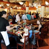 GLENVIEW, IL - OCTOBER 4:  A server delivers food to customers at a Corner Bakery Cafe October 4, 2005 in Glenview, Illinois. Dallas-based Brinker International has agreed to sell their Corner Bakery Cafe restaurants to CBC Restaurant Corp. There are 92 Corner Bakery Cafes in eight states and Washington, DC. Other Brinker restaurants include Chili's Grill & Bar, Maggiano's Little Italy, On The Border Mexican Grill & Cantina and Romano's Macaroni Grill.  (Photo by Tim Boyle/Getty Images)
