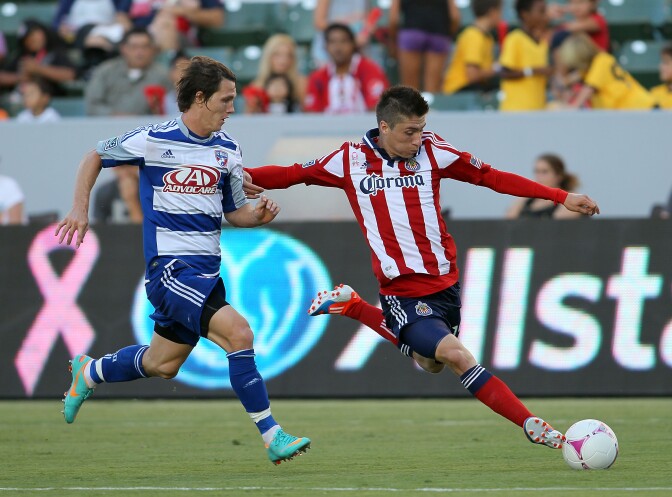 Jorge Villafana #19 of Chivas USA paces the ball on the attack a Zack Loyd #17 of FC Dallas in the second half during the MLS match at The Home Depot Center on October 7, 2012 in Carson, California. FC Dallas and Chivas USA played to a 1-1 draw.  