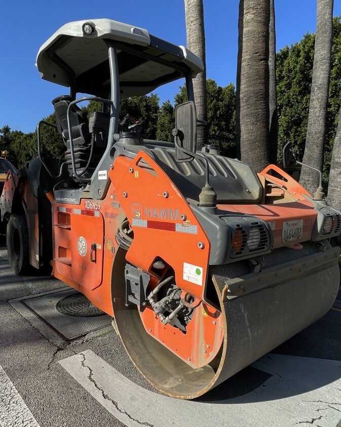 A machine that looks like a steam roller with giant drums on the front.