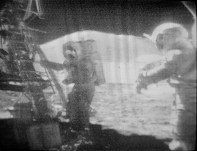 Two astronauts step onto surface of moon