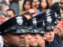 Police recruits attend their graduation ceremony at LAPD Headquarters where rappers Snoop Dogg and The Game led a peaceful demonstration outside on July 8, 2016 in Los Angeles, California, in what they called an effort to promote unity in the aftermath of the deadly shootings of police officers in Dallas.

 / AFP / Frederic J. BROWN        (Photo credit should read FREDERIC J. BROWN/AFP/Getty Images)