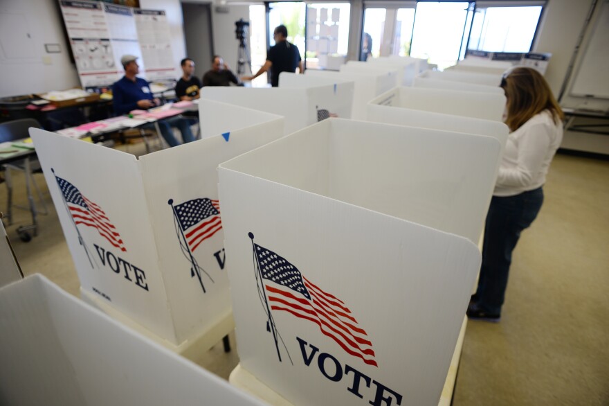 People vote at a polling place at the lifeguard station in Manhattan Beach, California, November 4, 2014.