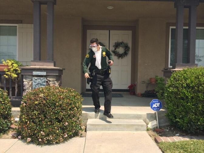 Sheriffs running around Blackstine Street in Rancho Cucamonga knocking on doors, telling residents to evacuate immediately, on Wednesday, April 30, 2014.