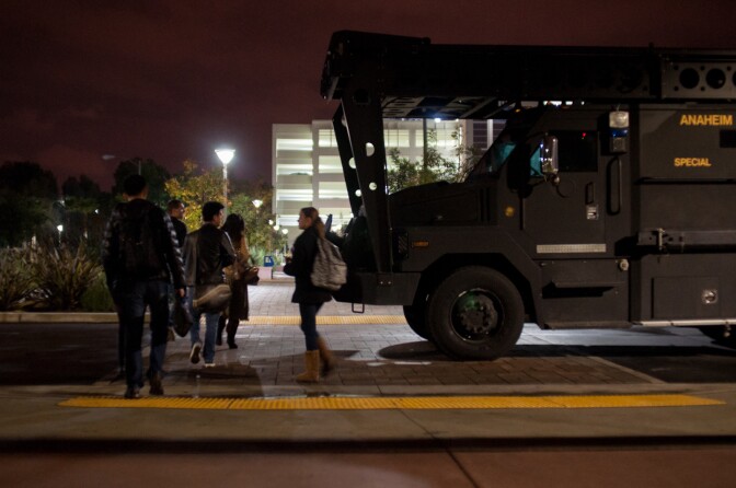 Students walk through campus after their buildings were cleared at Cal State Fullerton in Fullerton, Calif., Wednesday, Dec. 12, 2012. One of five robbery suspects, believed to be armed, allegedly barricaded himself inside a building on campus.
